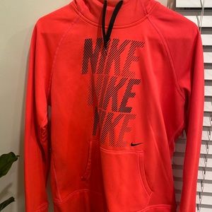 Bright pink Nike hoodie.